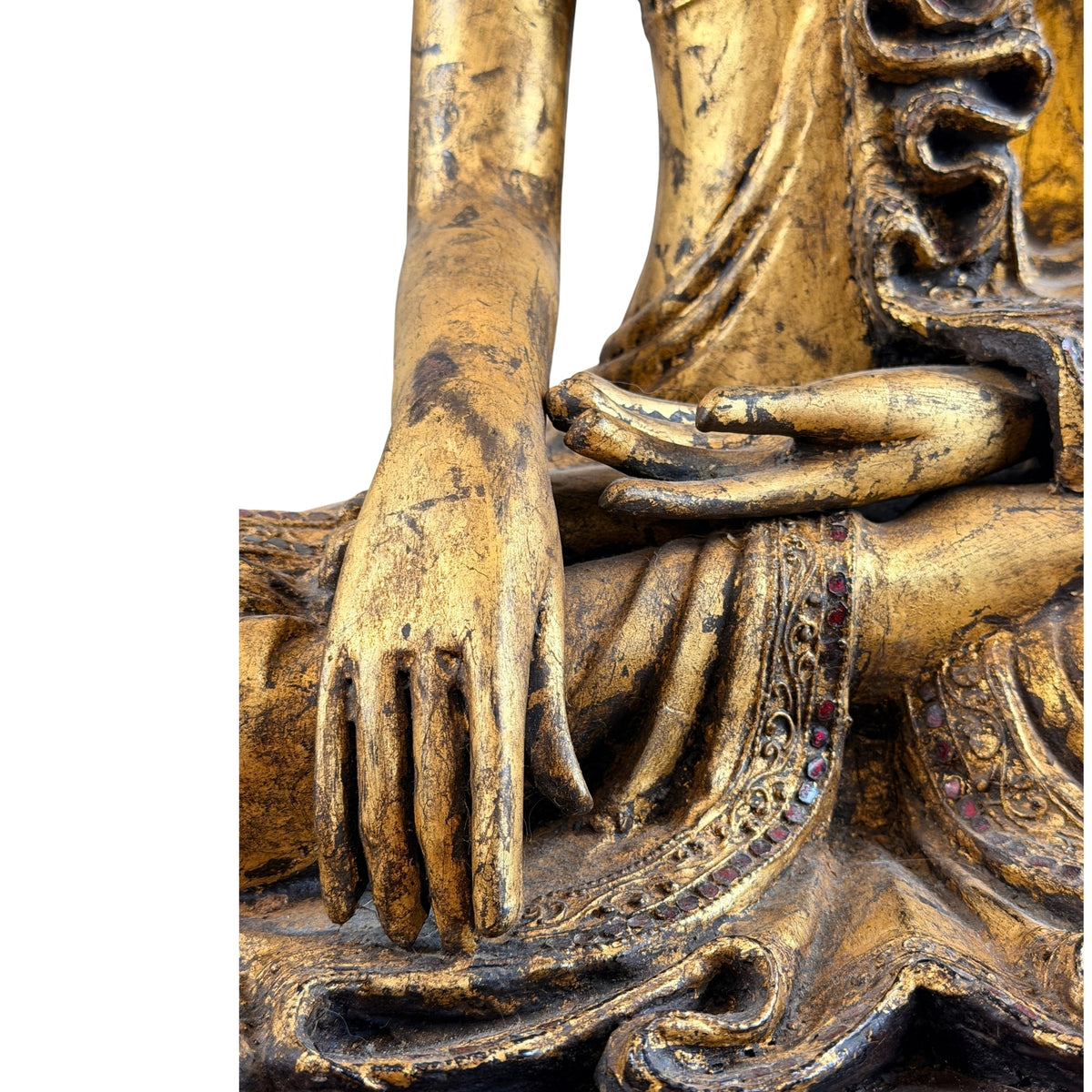 Detail van de handen in bhumisparsha mudra en de versierde gewaadzoom