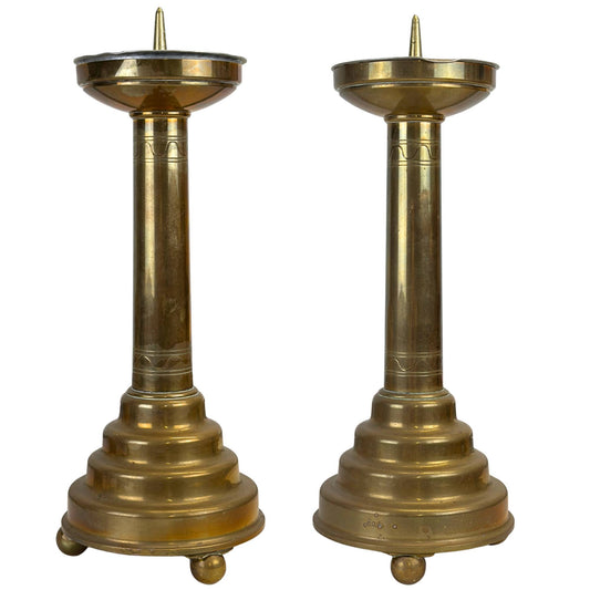 Set decoratieve messing kandelaars in klassieke altaarstijl met getrapte voet en bolpootjes.