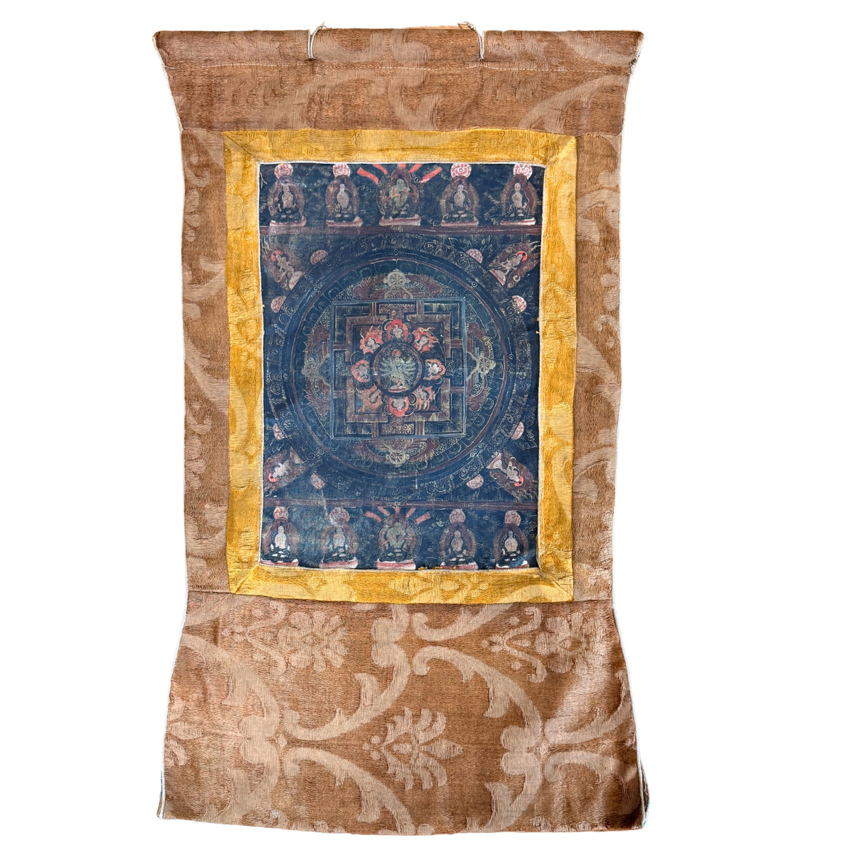 Himalaya mandala-thangka met donkerblauwe mandala in gele zijden binnenrand en verschoten bruin zijdedamast, vooraanzicht met ophanglussen