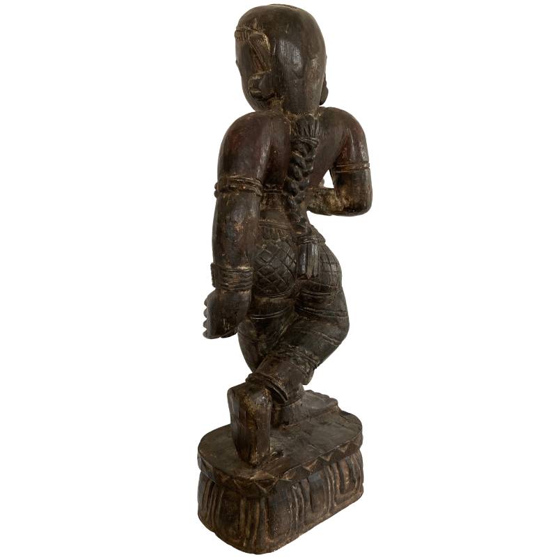Detail of old paint layers on antique Indian wooden temple sculpture