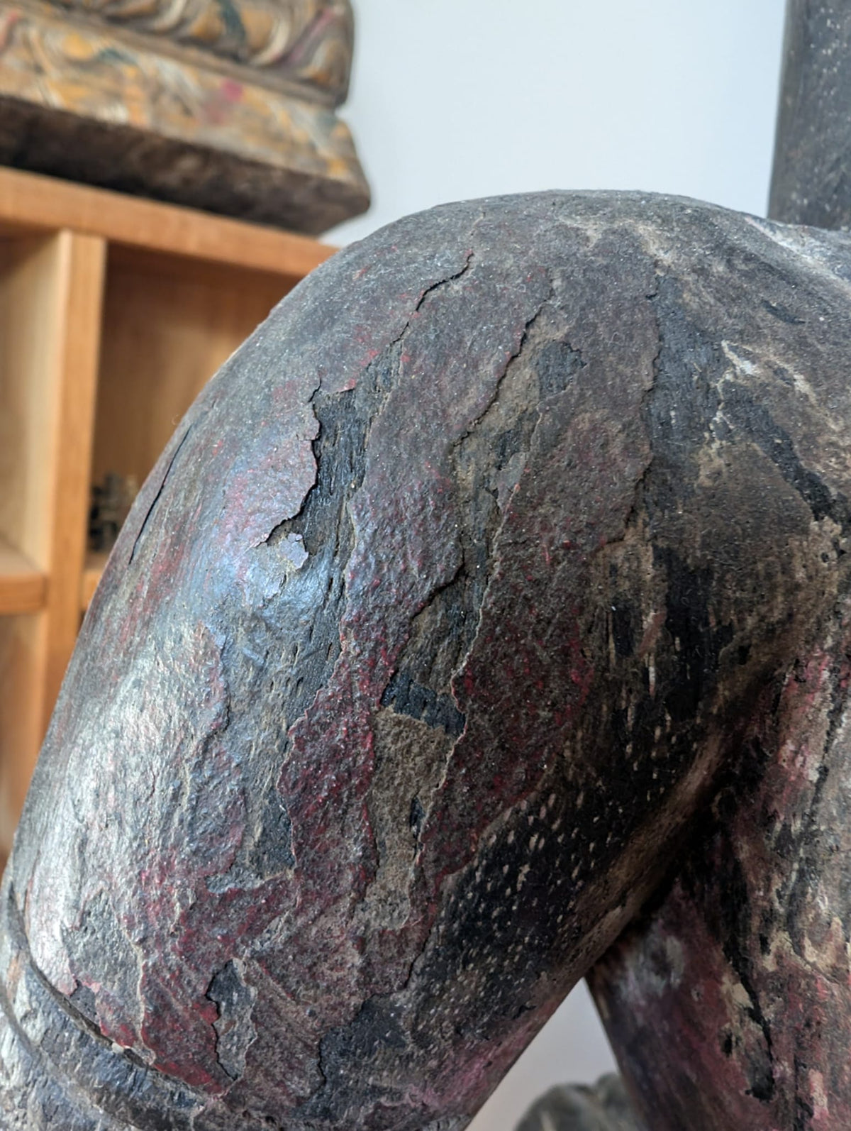 Craquelure and patina detail on antique Indian polychrome wooden figure