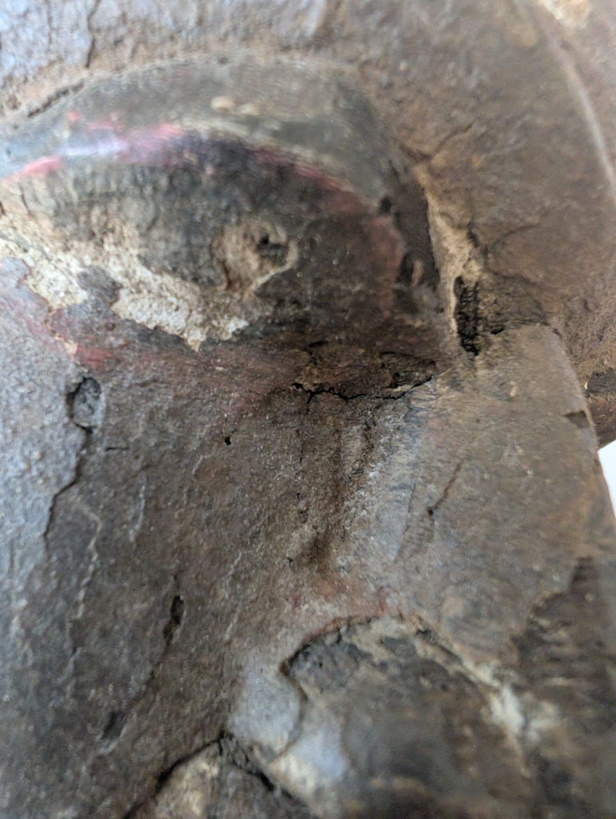 Aged surface and patina detail on antique Indian wooden temple figure