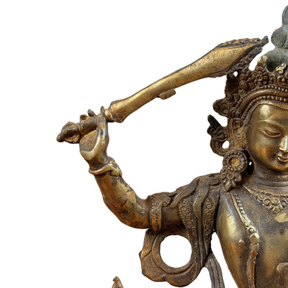 Opgeheven arm van Manjushri met het zwaard boven de kroon