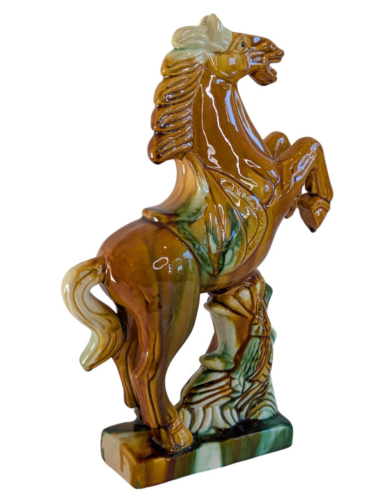 Steigerend paard van geglazuurd porselein gezien van de linkerzijde